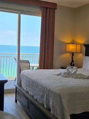 a bedroom with a bed with a view of the ocean at Ocean Front Condo Panama City Beach in Panama City Beach