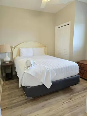 a bedroom with a bed with a teddy bear on it at Ocean Front Condo Panama City Beach in Panama City Beach