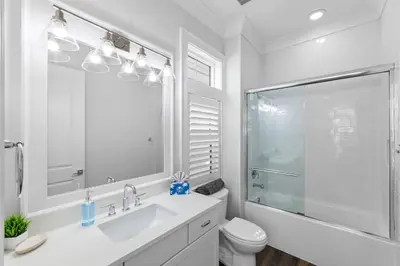 a white bathroom with a sink and a shower at Long To Sea by Travel Life Vacations in Santa Rosa Beach