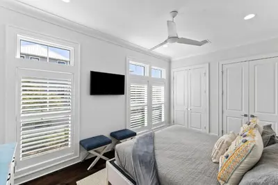 a bedroom with a bed and a flat screen tv at Long To Sea by Travel Life Vacations in Santa Rosa Beach