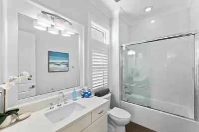 a white bathroom with a sink and a shower at Long To Sea by Travel Life Vacations in Santa Rosa Beach