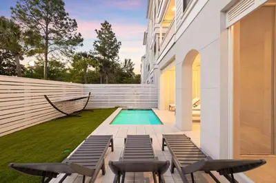 a swimming pool in the backyard of a house at Long To Sea by Travel Life Vacations in Santa Rosa Beach