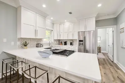 a kitchen with white cabinets and a white counter top at Majestic View by Travel Life Vacations in Santa Rosa Beach