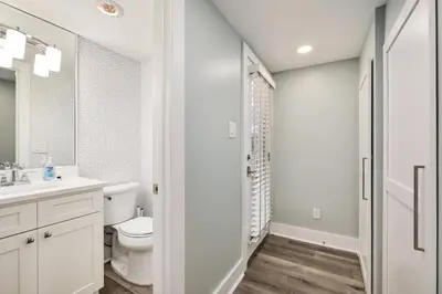 a white bathroom with a toilet and a shower at Majestic View by Travel Life Vacations in Santa Rosa Beach