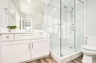 a white bathroom with a shower and a toilet at Majestic View by Travel Life Vacations in Santa Rosa Beach