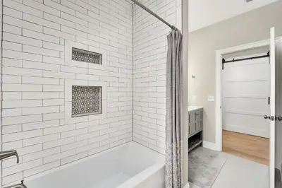 a white bathroom with a tub and a shower at Palm Royale by Travel Life Vacations in Inlet Beach