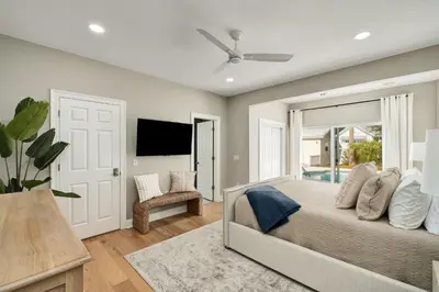 a bedroom with a large bed and a tv at Palm Royale by Travel Life Vacations in Inlet Beach