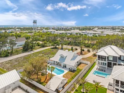 an aerial view of a villa with a pool and a house at Palm Royale by Travel Life Vacations in Inlet Beach