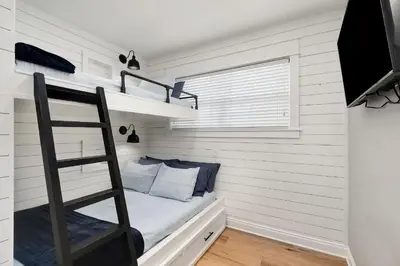 a room with a bunk bed and a ladder at Palm Royale by Travel Life Vacations in Inlet Beach