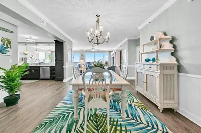 a kitchen and dining room with a table and chairs at Hidden Dunes 1605 in Panama City Beach