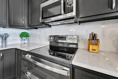 a kitchen with a stove and a microwave at Hidden Dunes 1605 in Panama City Beach