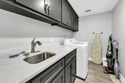 a kitchen with a sink and a washing machine at Hidden Dunes 1605 in Panama City Beach