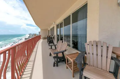 a balcony with chairs and the ocean at Hidden Dunes 1605 in Panama City Beach