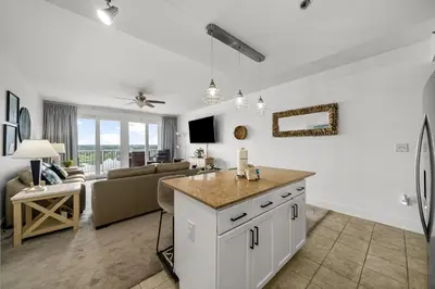 a kitchen and living room with a couch and a table at Laketown Wharf #0830 in Panama City Beach
