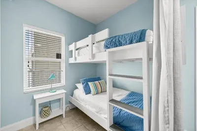 a bedroom with two bunk beds and a window at Laketown Wharf #0830 in Panama City Beach