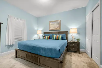 a blue bedroom with a bed and a window at Laketown Wharf #0830 in Panama City Beach