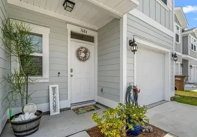 a front door of a house with a wreath on it at Panama City Beach Cozy Townhouse in Panama City Beach