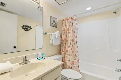 a bathroom with a sink and a toilet at Commodore 1009 in Panama City Beach