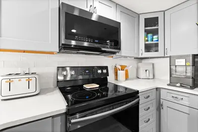 a kitchen with a black stove and a microwave at One Seagrove Place 0204 in Santa Rosa Beach