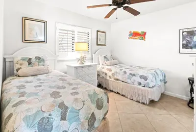 a bedroom with two beds and a ceiling fan at One Seagrove Place 0502 in Santa Rosa Beach