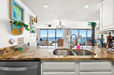 a kitchen with a sink and a view of the ocean at One Seagrove Place 0502 in Santa Rosa Beach