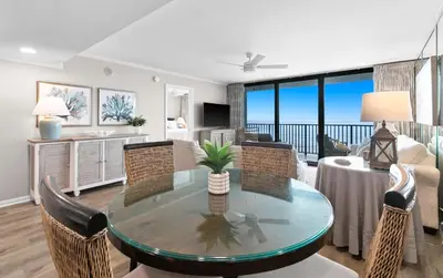 a living room with a dining table and a living room at One Seagrove Place 0904 in Santa Rosa Beach
