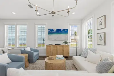 a living room with a couch and chairs and a chandelier at Spacious 6BR Beach Home Sleeps 15 – Relax & Reconnect at Coastal Breeze in Panama City Beach