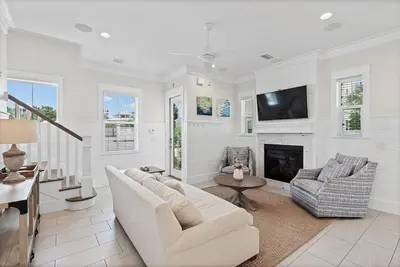 a living room with a couch and a fireplace at Mermaid Cove in Inlet Beach