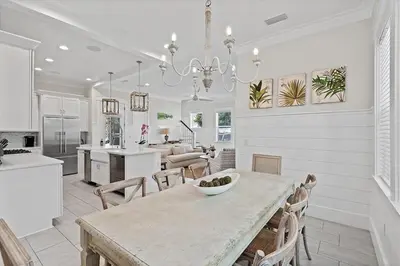 a dining room and kitchen with a table and chairs at Mermaid Cove in Inlet Beach
