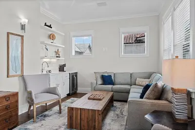 a living room with a couch and a table at Mermaid Cove in Inlet Beach