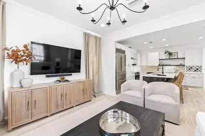 a living room with a flat screen tv on a entertainment center at Coastal Cabana in Inlet Beach