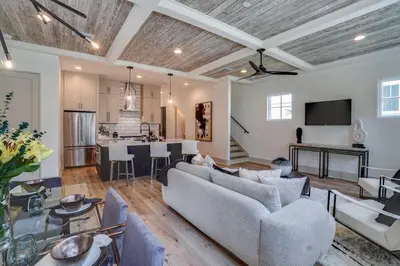 a living room with two couches and a kitchen at No Bad Day on 30A in Inlet Beach