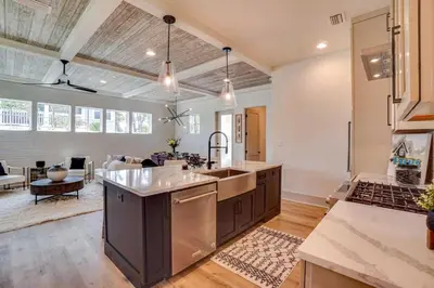 an open kitchen and living room with a sink at No Bad Day on 30A in Inlet Beach