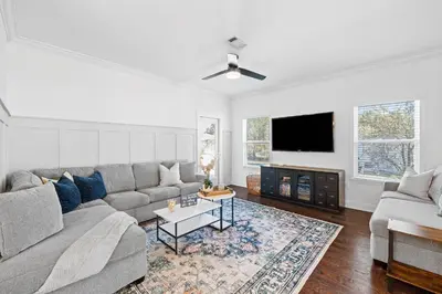 a living room with a couch and a flat screen tv at Beach Bliss in Inlet Beach