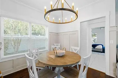 a dining room with a table and chairs and a chandelier at Beach Bliss in Inlet Beach