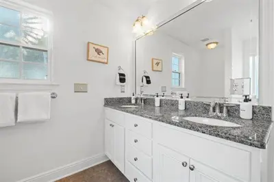 a bathroom with a sink and a large mirror at Beach Bliss in Inlet Beach