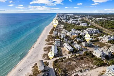 an aerial view of a beach with two yellow balloons at Grandy 30A in Inlet Beach