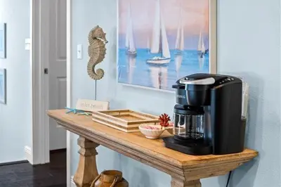 a coffee maker on a wooden table in a room at Inlet Love in Inlet Beach