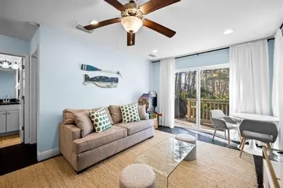 a living room with a couch and a ceiling fan at Inlet Love in Inlet Beach