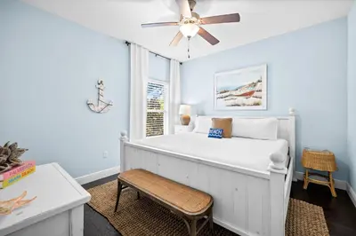 a bedroom with a white bed and a ceiling fan at Inlet Love in Inlet Beach