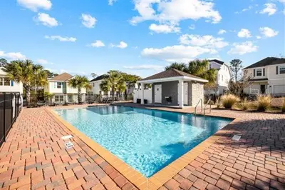 a large swimming pool in a yard with houses at Inlet Love in Inlet Beach