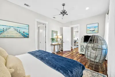 a living room with a bed and a fan at Soakin it Up in Inlet Beach