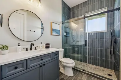 a bathroom with a shower and a sink and a toilet at Soakin it Up in Inlet Beach