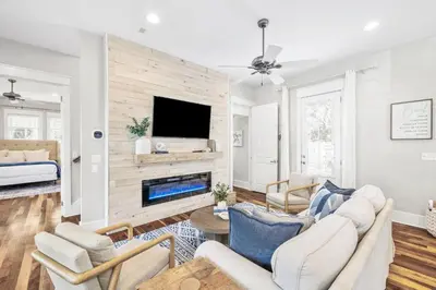 a living room with a couch and a fireplace at Soakin it Up in Inlet Beach