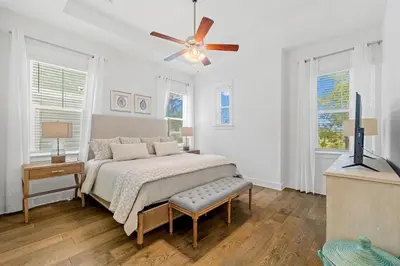 a bedroom with a bed and a ceiling fan at Heron's Nest in Inlet Beach