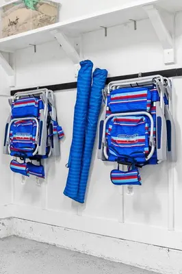a group of blue baseball equipment hanging on a wall at Heron's Nest in Inlet Beach