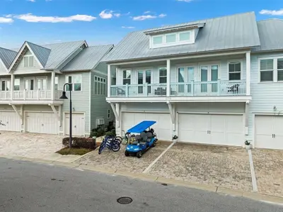 a blue car parked in front of a house at Heron's Nest in Inlet Beach