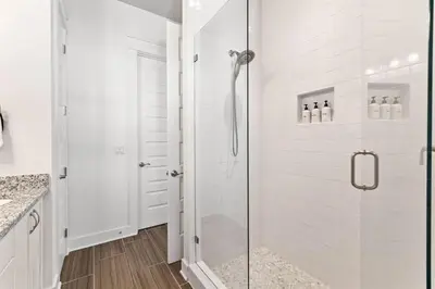 a shower with a glass door in a bathroom at Island Lullaby in Inlet Beach