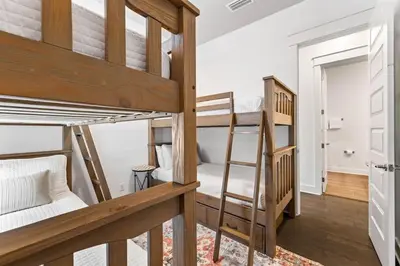 a room with two bunk beds and a hallway at Island Lullaby in Inlet Beach