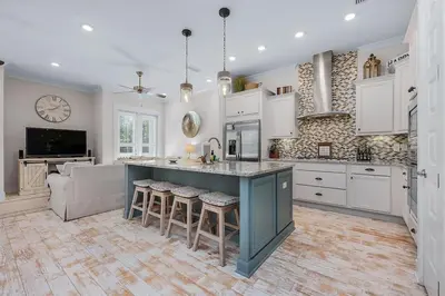 a kitchen with a large island with stools at Lucky Beach in Inlet Beach